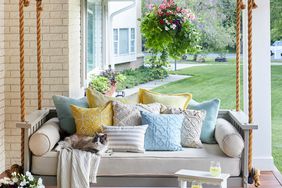 porch swing with cat and throw pillows