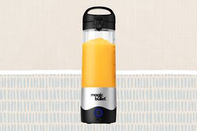 The Magic Bullet Portable Blender over a tan patterned background.