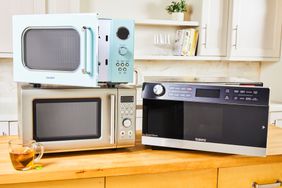 A variety of countertop microwaves on a kitchen countertop