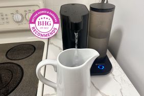 The Aquasana Clean Water Machine pouring water into a white pitcher with a BHG Recommends badge.