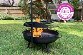 Barebones Living Cowboy Fire Pit Grill ignites on the lawn radiating warmth and charm